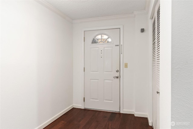 foyer with ornamental molding, dark hardwood / wood-style flooring, and a textured ceiling