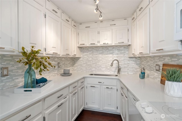 kitchen with sink, white cabinetry, stove, white dishwasher, and decorative backsplash