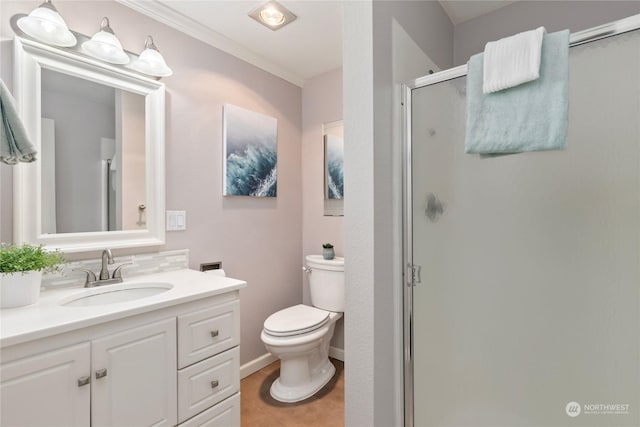 bathroom featuring vanity, crown molding, a shower with shower door, and toilet