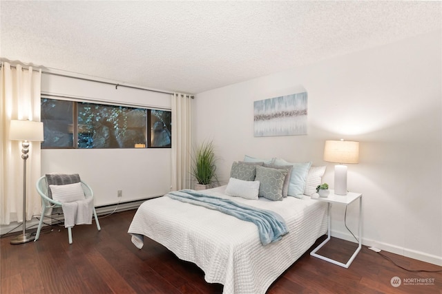 bedroom with a textured ceiling and dark hardwood / wood-style flooring