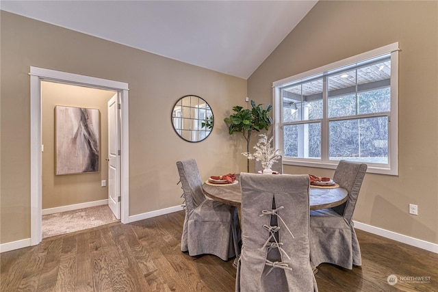 dining area with wood-type flooring and vaulted ceiling