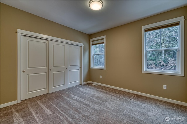 unfurnished bedroom featuring a closet and carpet