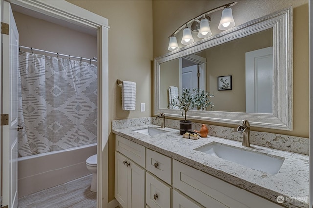 full bathroom featuring hardwood / wood-style flooring, shower / tub combo with curtain, vanity, and toilet