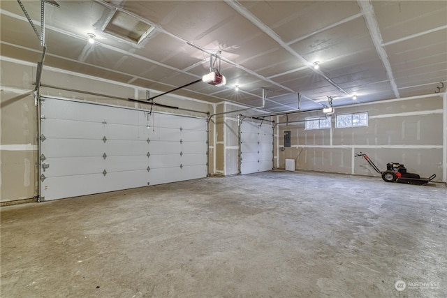 garage with a garage door opener and electric panel