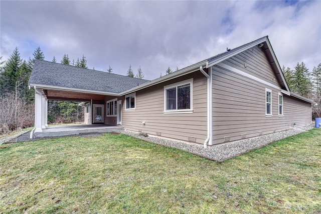 rear view of house with a patio and a lawn