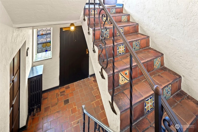 stairway with a textured ceiling