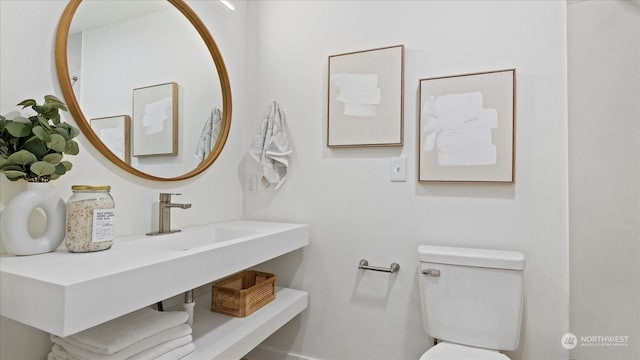 bathroom featuring sink and toilet