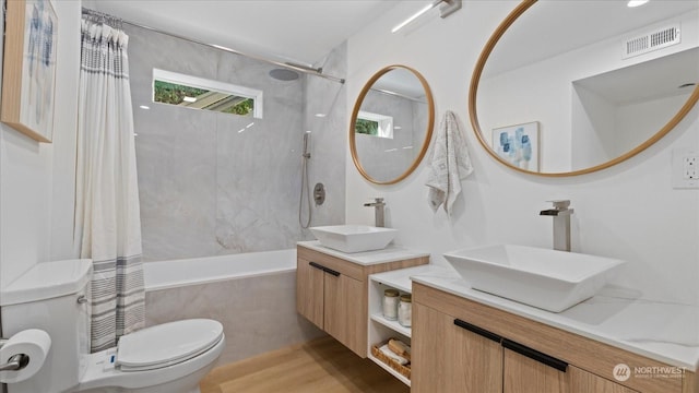 full bathroom featuring vanity, toilet, and shower / bath combo with shower curtain