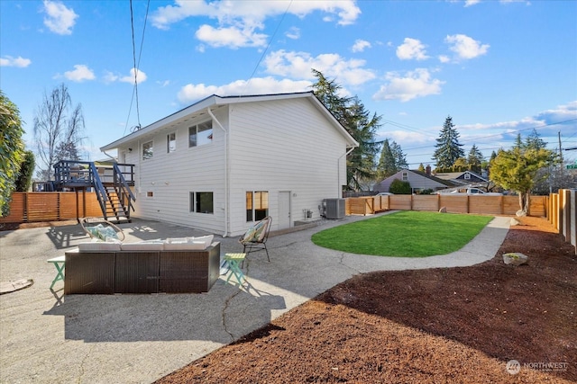 rear view of house with an outdoor hangout area, central AC unit, a patio area, and a lawn