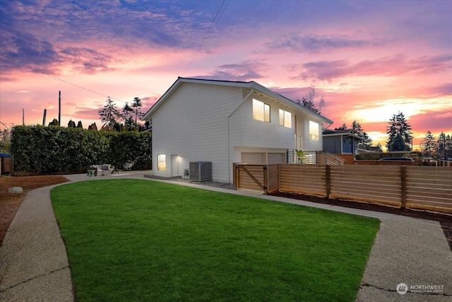 exterior space featuring a yard and central air condition unit