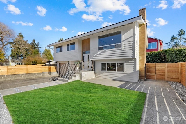 back of house featuring a yard