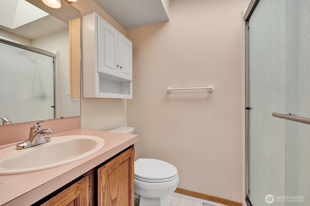 bathroom with an enclosed shower, vanity, toilet, and baseboards