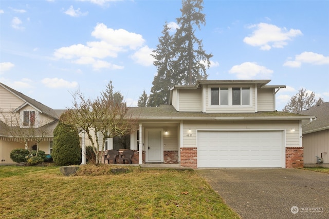 view of front of house with a garage and a front lawn