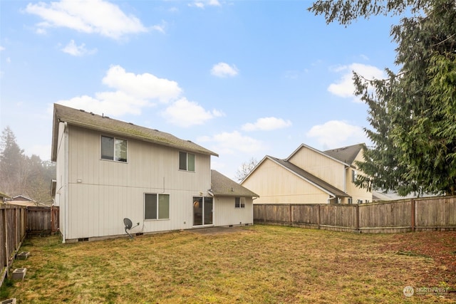 rear view of property with a yard