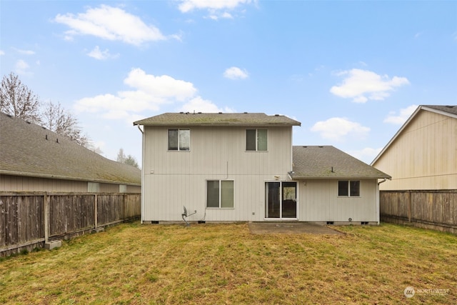 back of house featuring a patio and a yard