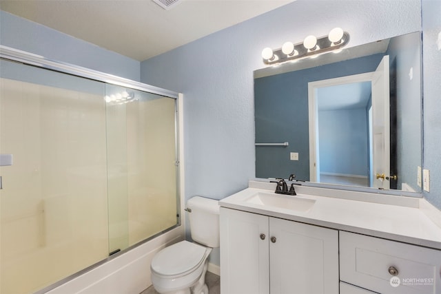 full bathroom with vanity, enclosed tub / shower combo, and toilet