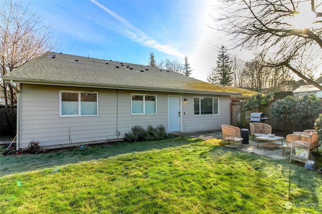 back of house featuring a lawn and a patio