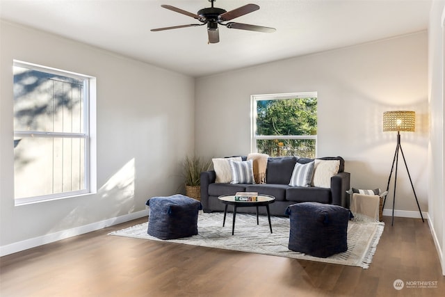 living room featuring wood-type flooring, lofted ceiling, and ceiling fan