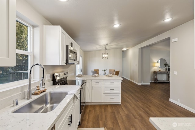 kitchen with white cabinetry, stainless steel appliances, and sink