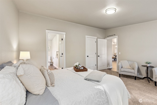 carpeted bedroom featuring ensuite bathroom