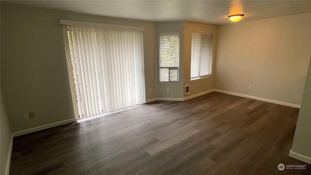 empty room with dark hardwood / wood-style floors