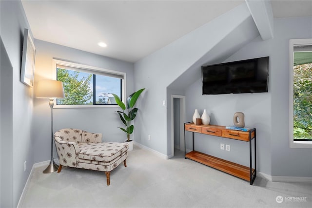 sitting room featuring light carpet and vaulted ceiling with beams