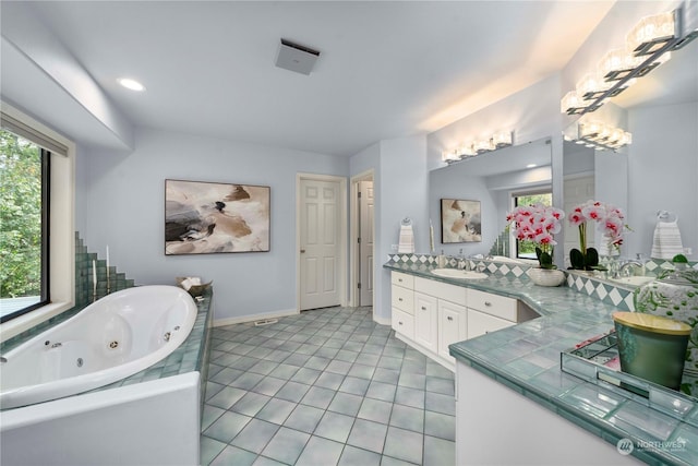 bathroom with tile patterned floors, vanity, and a bathing tub