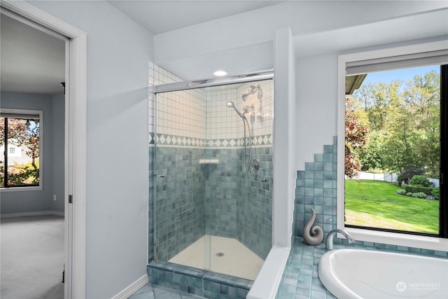 bathroom featuring shower with separate bathtub