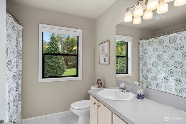 bathroom with vanity, tile patterned floors, toilet, and an inviting chandelier