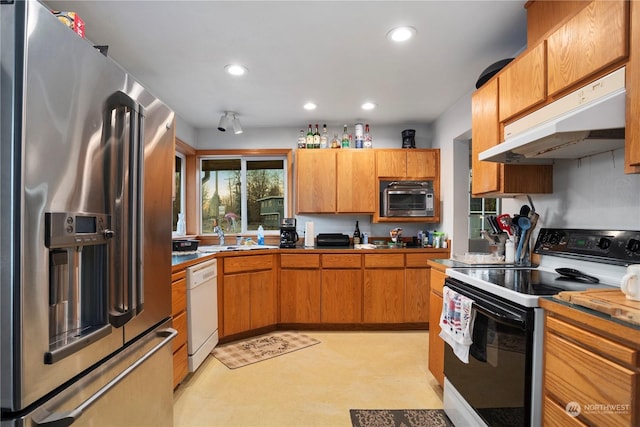 kitchen with range with electric cooktop, high end refrigerator, white dishwasher, and sink