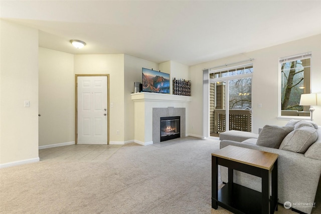 living room featuring a tile fireplace and light carpet