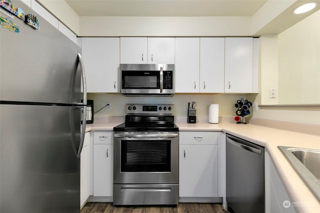 kitchen featuring white cabinetry, stainless steel appliances, dark hardwood / wood-style flooring, and sink