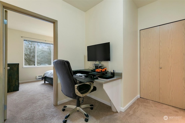 carpeted office space with baseboard heating