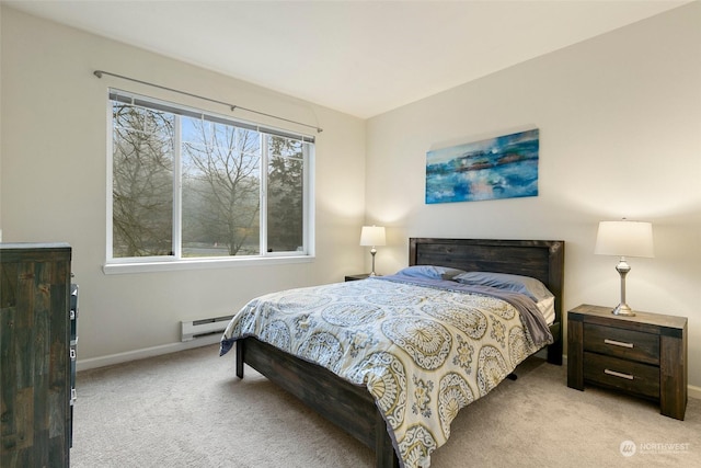 carpeted bedroom featuring a baseboard heating unit