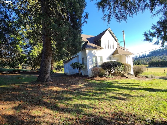 view of side of property with a yard