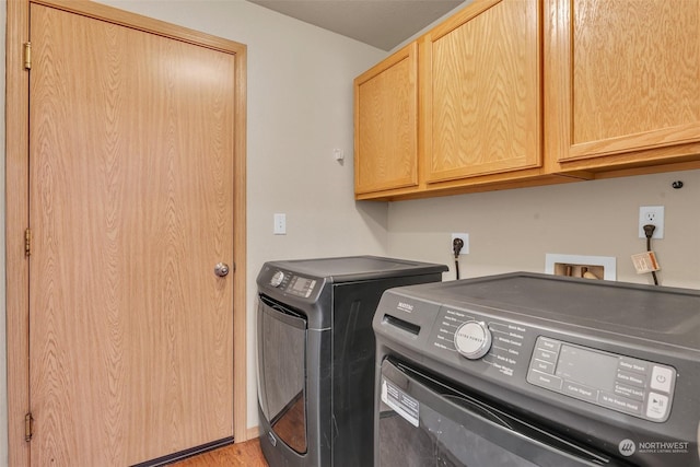 washroom with cabinets and separate washer and dryer