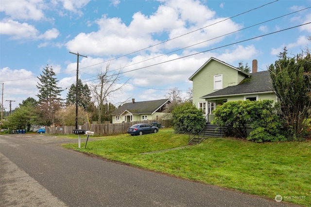 view of side of property with a yard