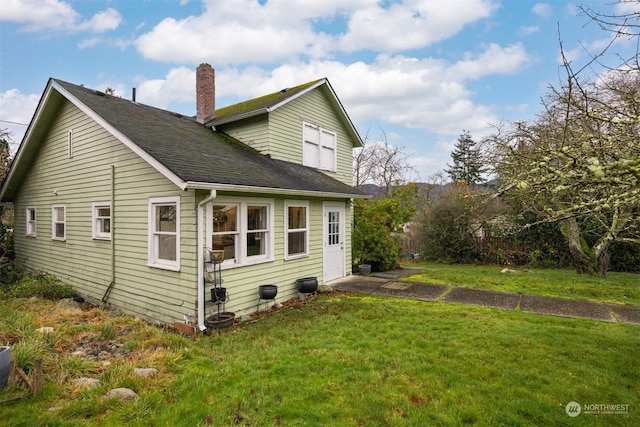 rear view of house with a yard