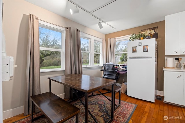 dining space with light hardwood / wood-style floors