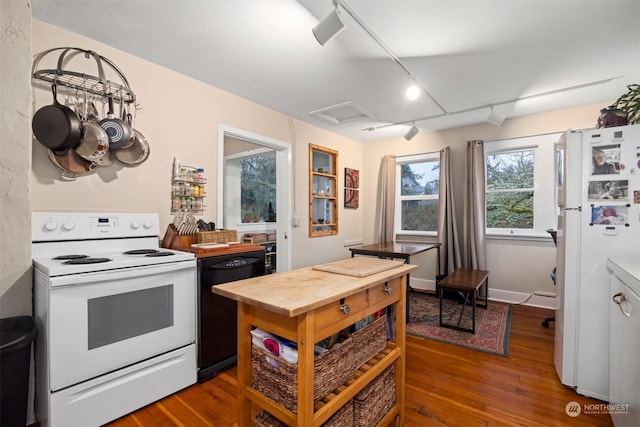 kitchen with hardwood / wood-style floors, white appliances, and track lighting