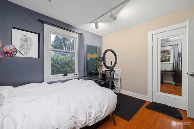 bedroom with hardwood / wood-style floors