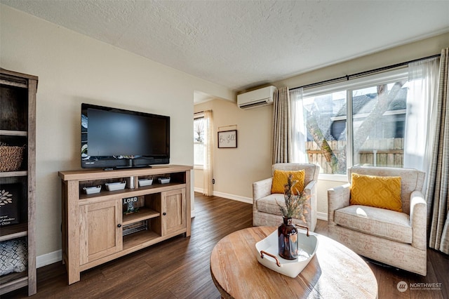 living room with dark hardwood / wood-style flooring, a wall unit AC, and a textured ceiling