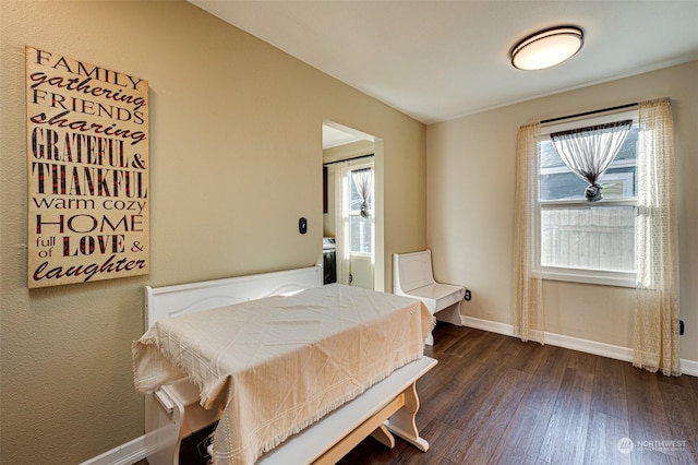 bedroom with dark hardwood / wood-style flooring