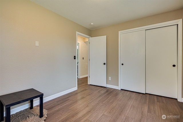 bedroom featuring light hardwood / wood-style flooring and a closet