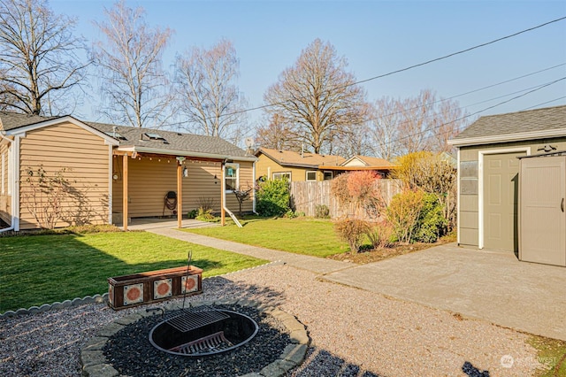 back of property featuring a yard, a patio area, and a shed