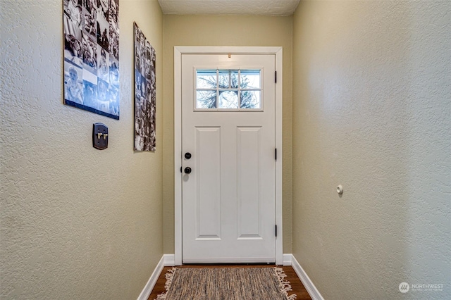 doorway to outside featuring hardwood / wood-style flooring and a textured ceiling