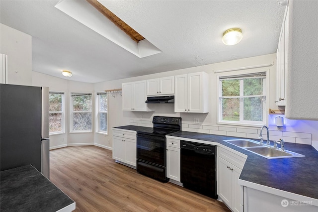 kitchen with white cabinetry, sink, black appliances, and light wood-type flooring