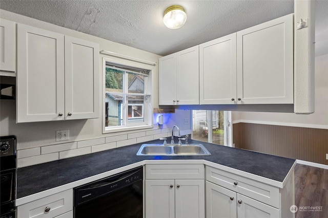 kitchen featuring sink, a textured ceiling, black dishwasher, white cabinets, and stove