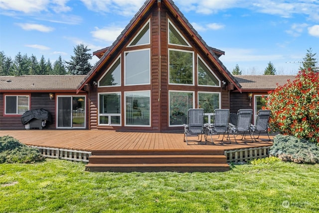 back of house with a wooden deck and a yard