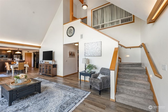 living room featuring high vaulted ceiling and dark hardwood / wood-style flooring